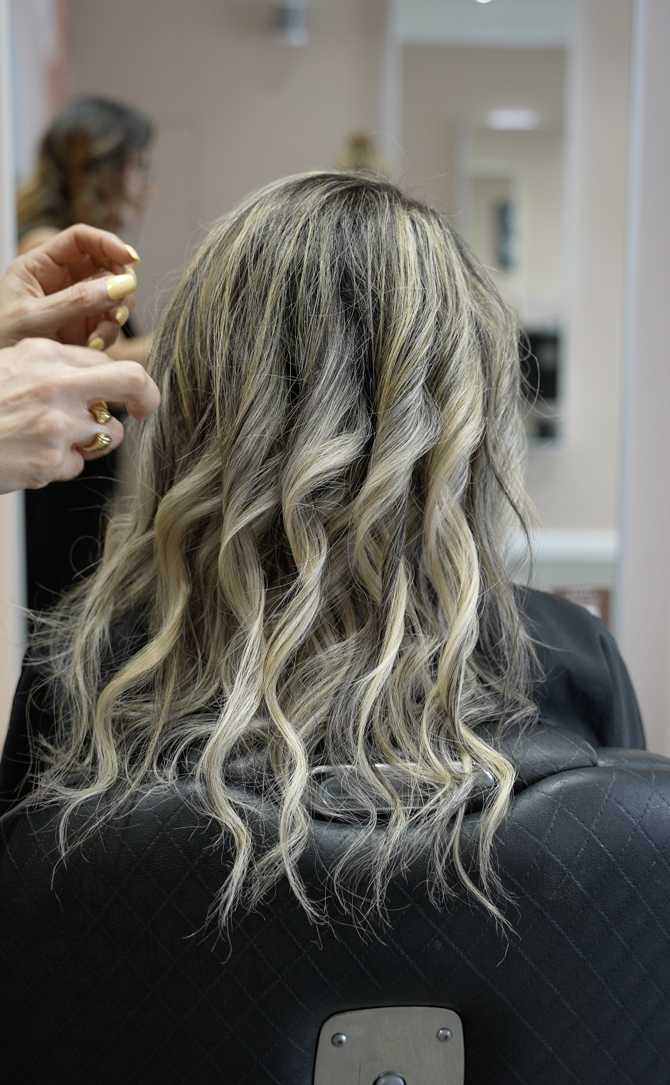 Wavy blonde hair with a soft balayage, styled into loose waves