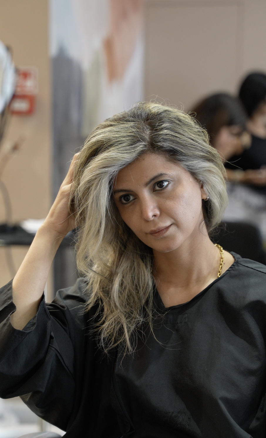 A client with a silver-blonde balayage after her colour appointment