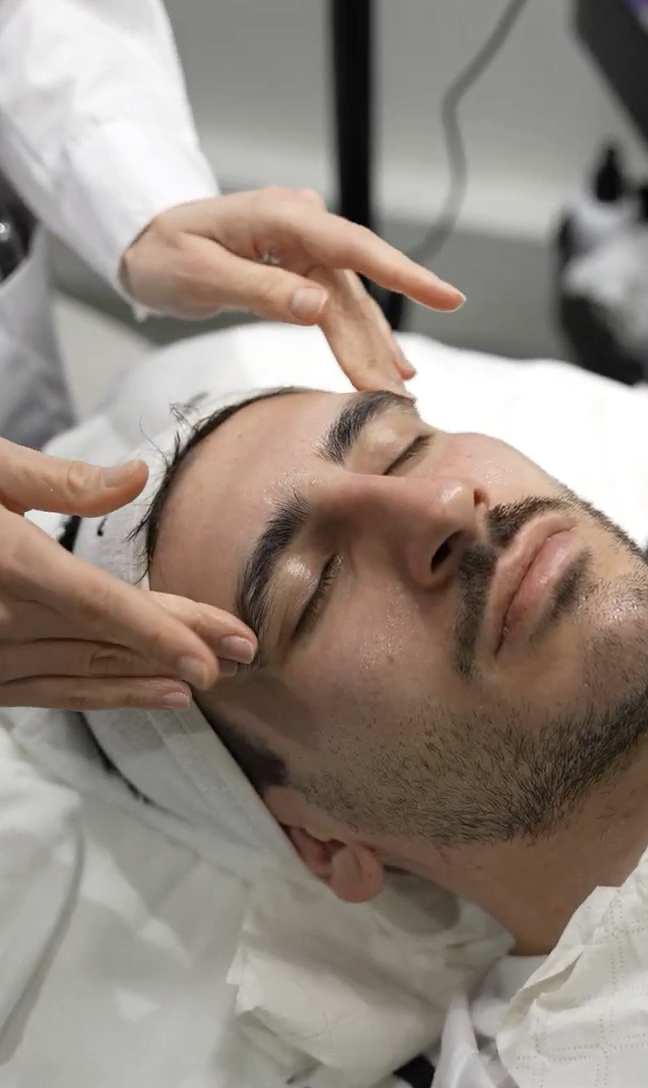 A client relaxing during a facial skin treatment